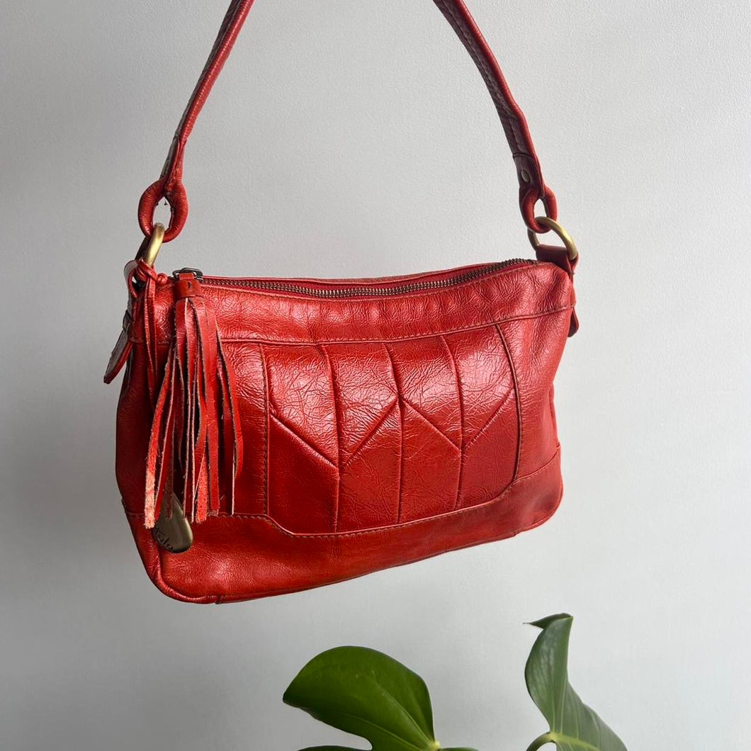 Orange leather bag with tassel detail